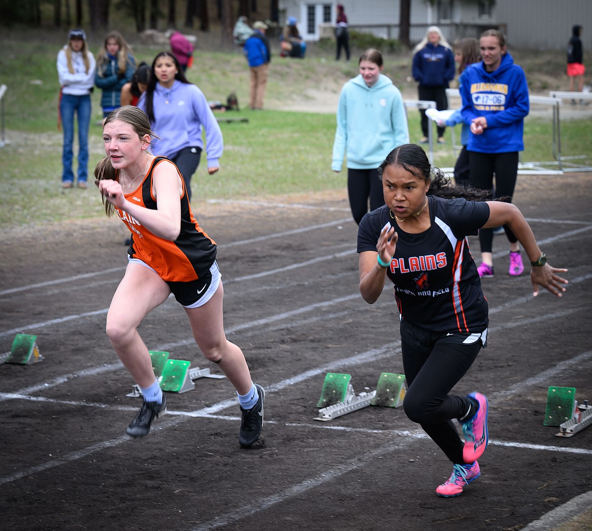 Plains sprinters Amy Hill (left) and Aly Roy give it their all in the 100 meter sprint event at this past week's Thompson Falls Invitational.  (Photo by Tracy Scott)