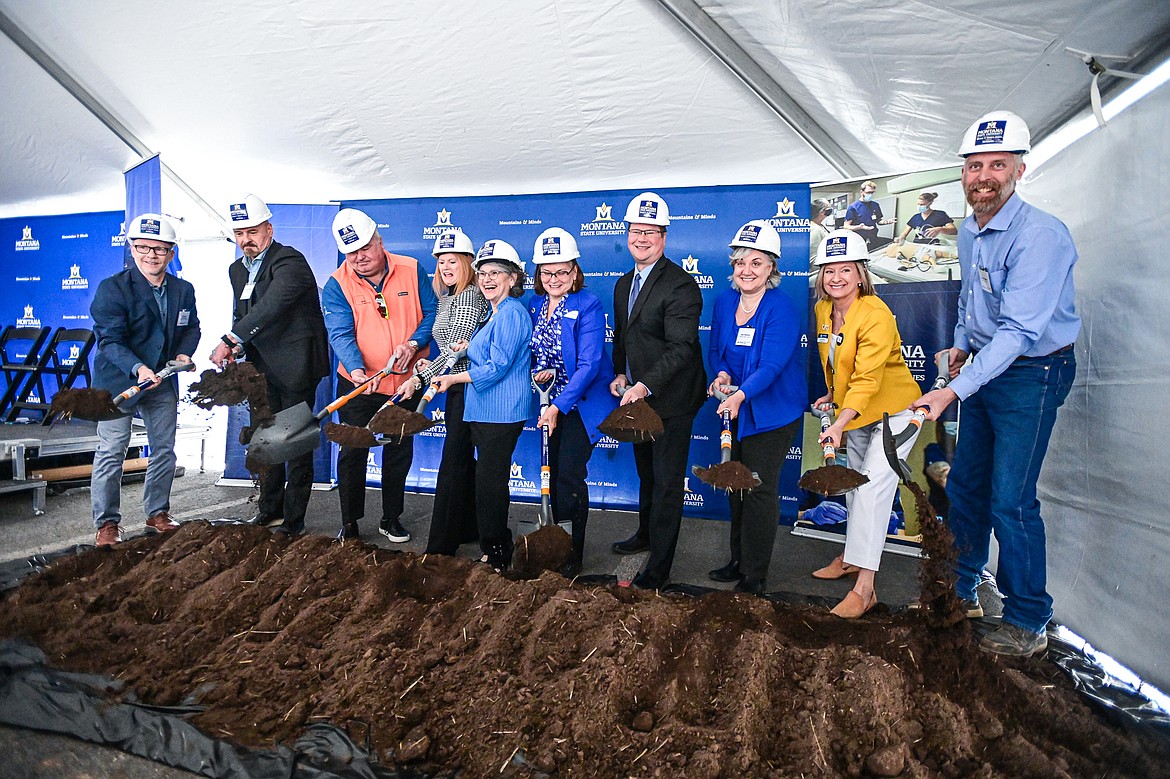 Dignitaries lift a ceremonial shovel of dirt during a groundbreaking ceremony for the Montana State University Mark and Robyn Jones College of Nursing building at Logan Health on Tuesday, April 23. (Casey Kreider/Daily Inter Lake)