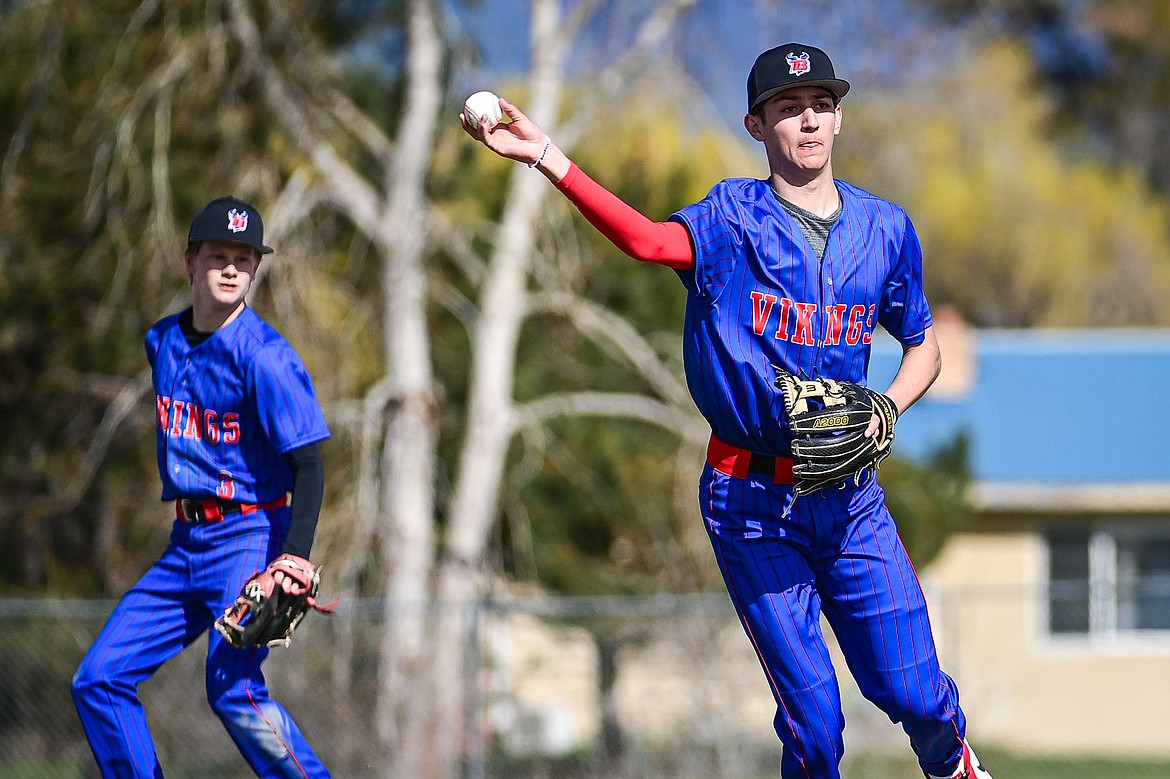 Bigfork third baseman Hayden Mayer (8) throws across the diamond for an out against Whitefish at ABS Park in Evergreen on Tuesday, April 23. Backing him up on the play is shortstop Grady Campbell. (Casey Kreider/Daily Inter Lake)