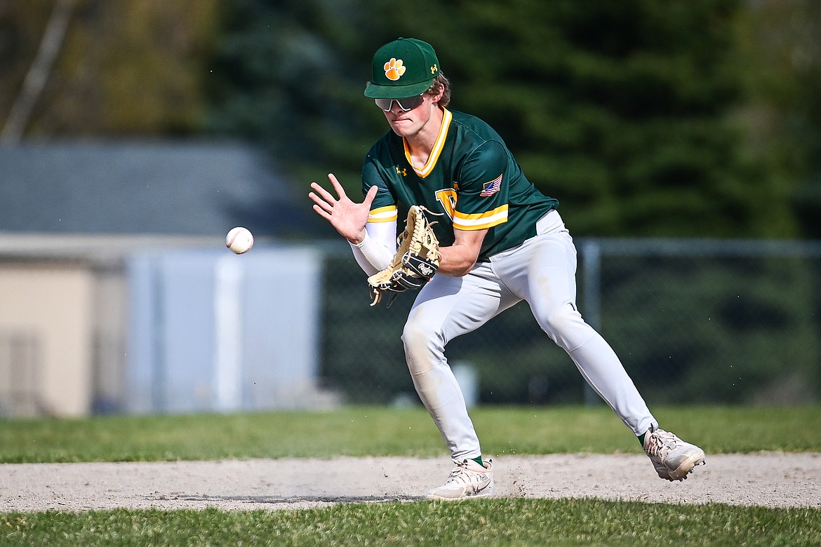 Whitefish shorstop Ryan Conklin (1) watches a grounder into his glove against Bigfork at ABS Park in Evergreen on Tuesday, April 23. (Casey Kreider/Daily Inter Lake)