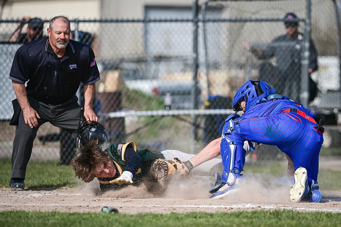 Bigfork catcher Liam Benson (7) puts the tag on Whitefish's Drew Queen (22) as Queen was trying to stretch a triple into an inside-the-park home run at ABS Park in Evergreen on Tuesday, April 23. (Casey Kreider/Daily Inter Lake)