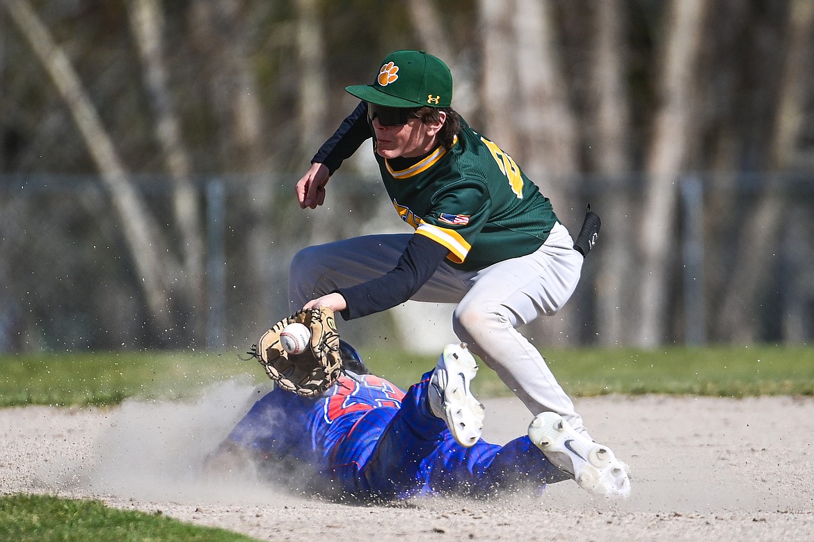 Bigfork's Ryeln Rodriguez (23) steals second base ahead of the tag by Whitefish second baseman Drew Queen (22) at ABS Park in Evergreen on Tuesday, April 23. (Casey Kreider/Daily Inter Lake)