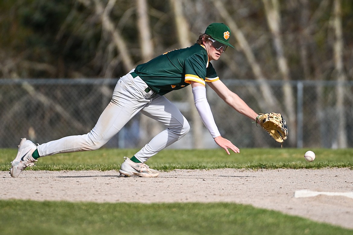 Whitefish shorstop Ryan Conklin (1) reaches for a grounder up the middle against Bigfork at ABS Park in Evergreen on Tuesday, April 23. (Casey Kreider/Daily Inter Lake)