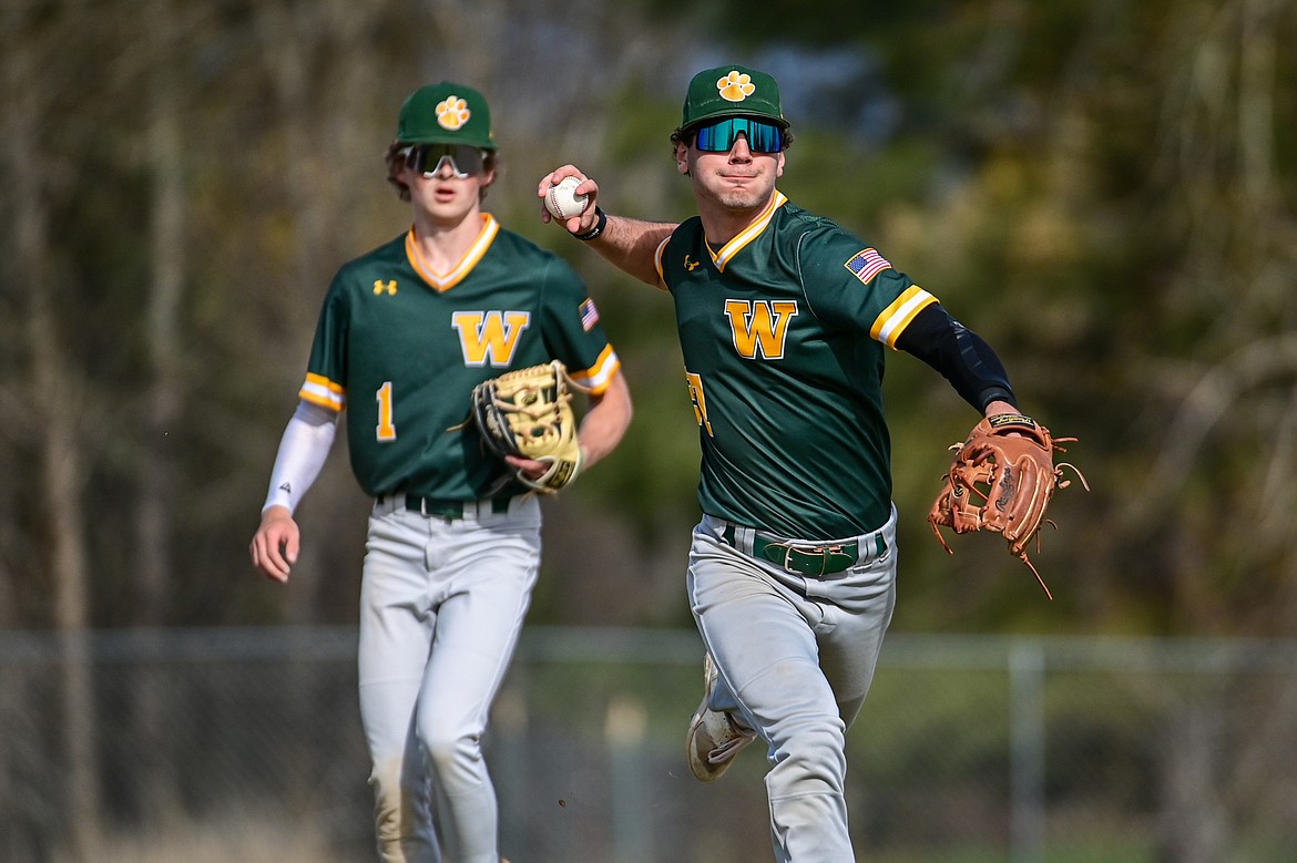 Whitefish third baseman Michael Miller (27) charges a grounder against Bigfork at ABS Park in Evergreen on Tuesday, April 23. (Casey Kreider/Daily Inter Lake)