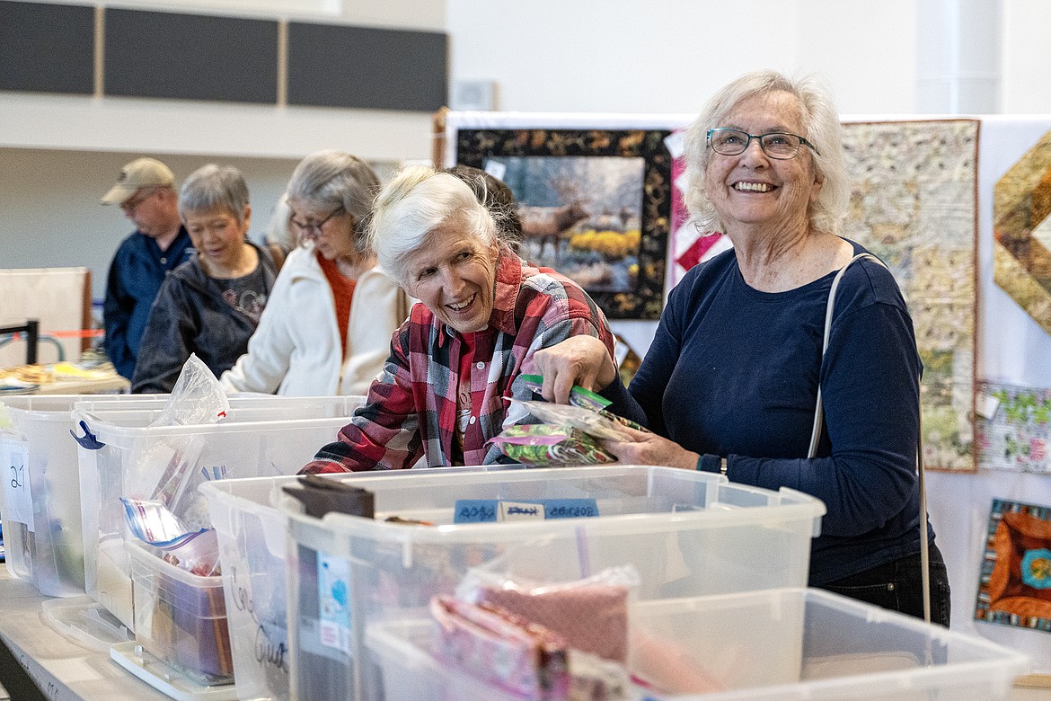 Visitors to the Teakettle Quilt Show peruse the boutique, filled with smaller handmade goods and quilting supplies, on Saturday, April 20.