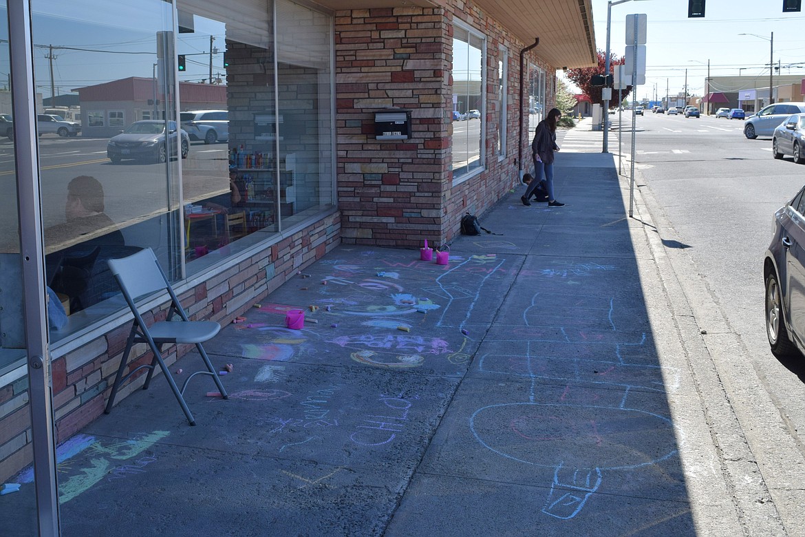 Drawings and chalk art outside the Othello Public Library from children attending the library’s Saturday Day of the Children event.