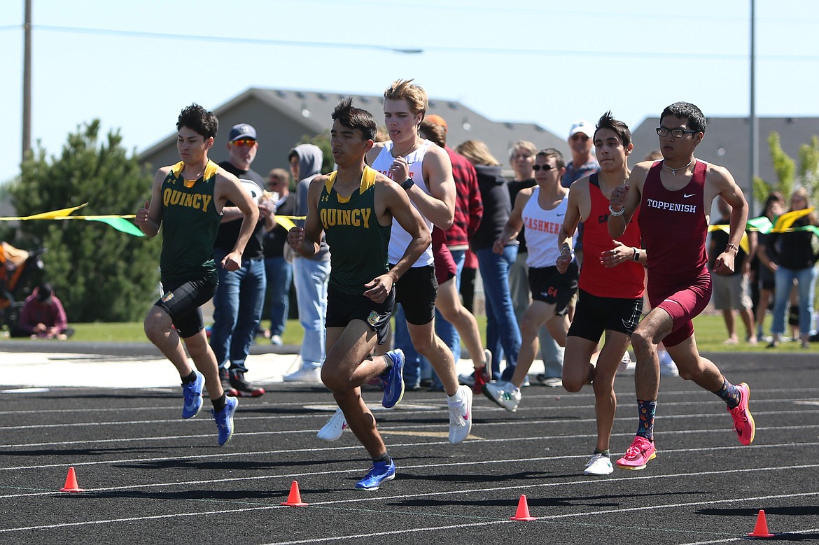 Runners compete during the second heat of the boys 800-meter run at Saturday’s CliftonLarsonAllen Quincy Invitational.