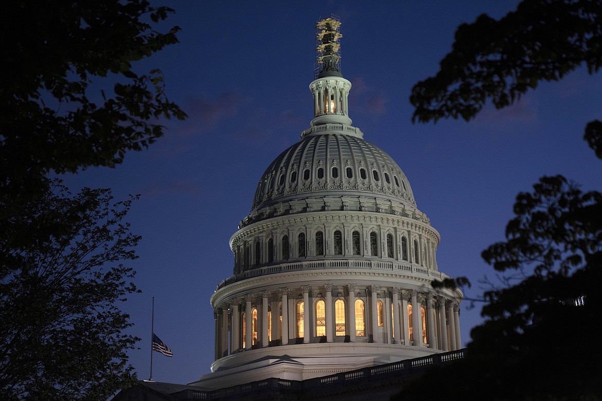 Night falls on the dome of the Capitol on Tuesday, Oct. 3, 2023 in Washington. (AP Photo/Mark Schiefelbein)
