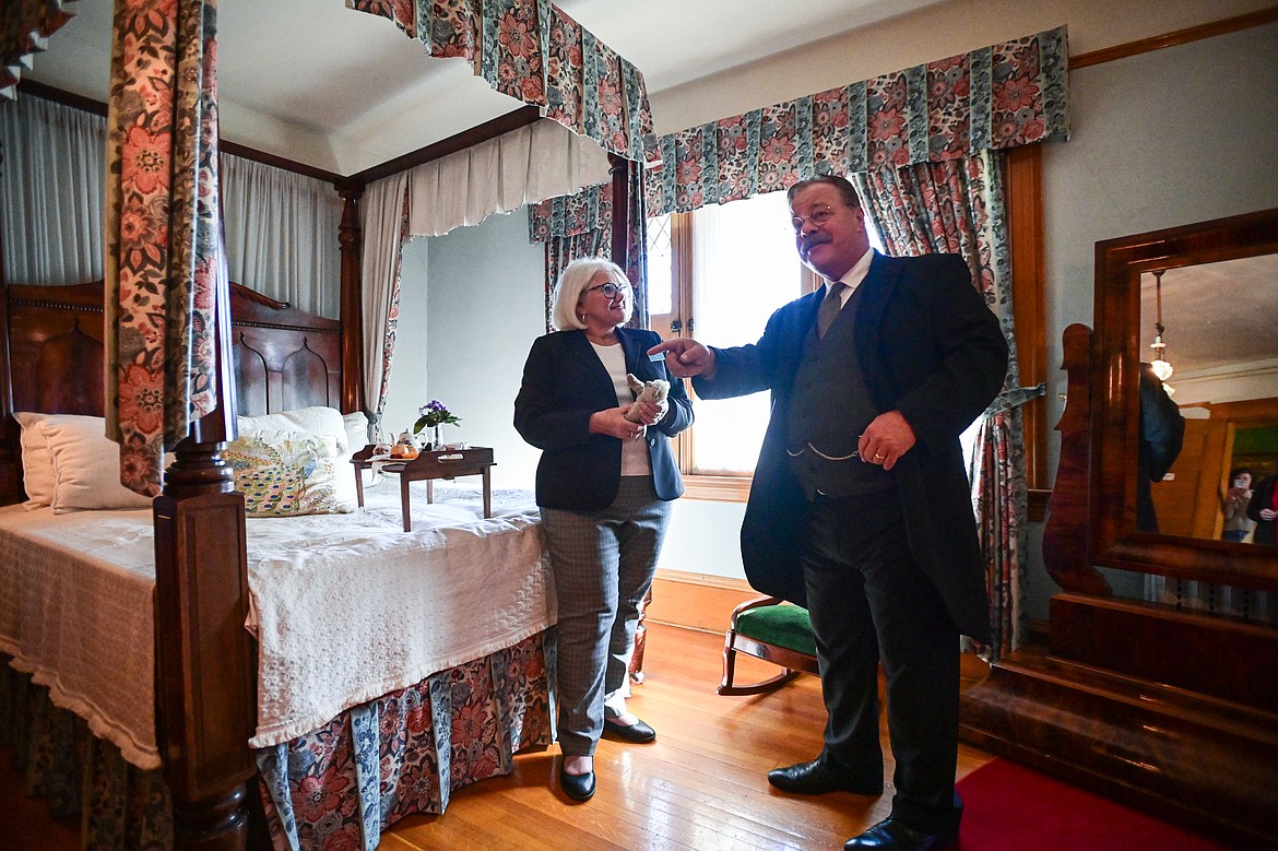 Impersonator Joe Wiegand, portraying 26th U.S. President Theodore Roosevelt, speaks with tour guide Cindy Conner during a visit to the Conrad Mansion in Kalispell on Wednesday, April 24. (Casey Kreider/Daily Inter Lake)