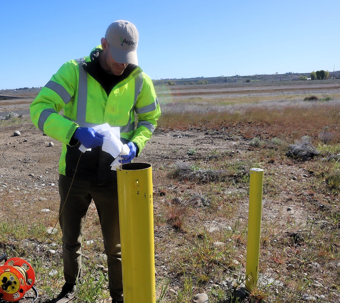 A contractor for the city of Moses Lake measures Well 20’s water levels Monday before the start of the well capacity test.