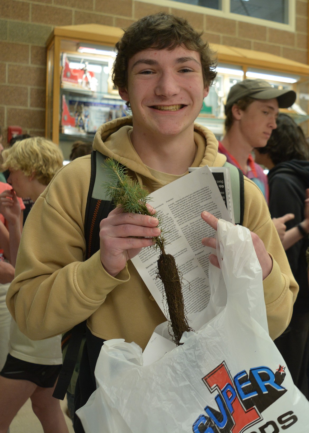 Cruz Harris-Novak bought a tree sapling from the Lake City student council during his lunch period Wednesday. The students decided to sell saplings from Coeur d’Alene Forest Nursery for climate awareness.