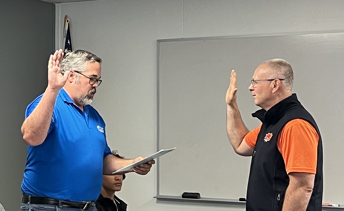 Matthew Truscott, left, is sworn into office by Superintendent Tim Payne as a member of the Ephrata School Board earlier this week. Truscott will serve the remainder of Alan Key’s term. Key resigned from the board in February.