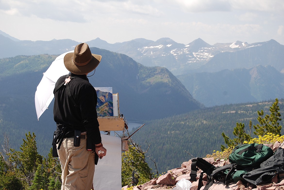 Rob Akey paints outside of Pendant Cabin in the Bob Marshall Wilderness. (Photo courtesy of Rob Akey)