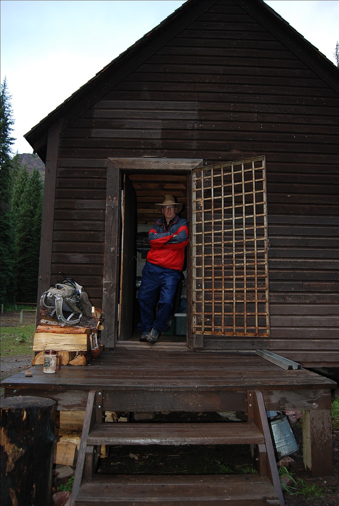 Rob Akey stands in the doorway of Pendant Cabin in the Bob Marshall Wilderness. (Photo courtesy of Rob Akey)