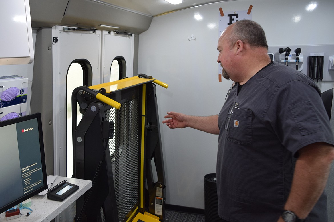 East Adams Rural Healthcare Certified Medical Assistant Jeff Kissler points out a chair lift that allows wheelchair-bound patients access to the EARH mobile clinic exam room.