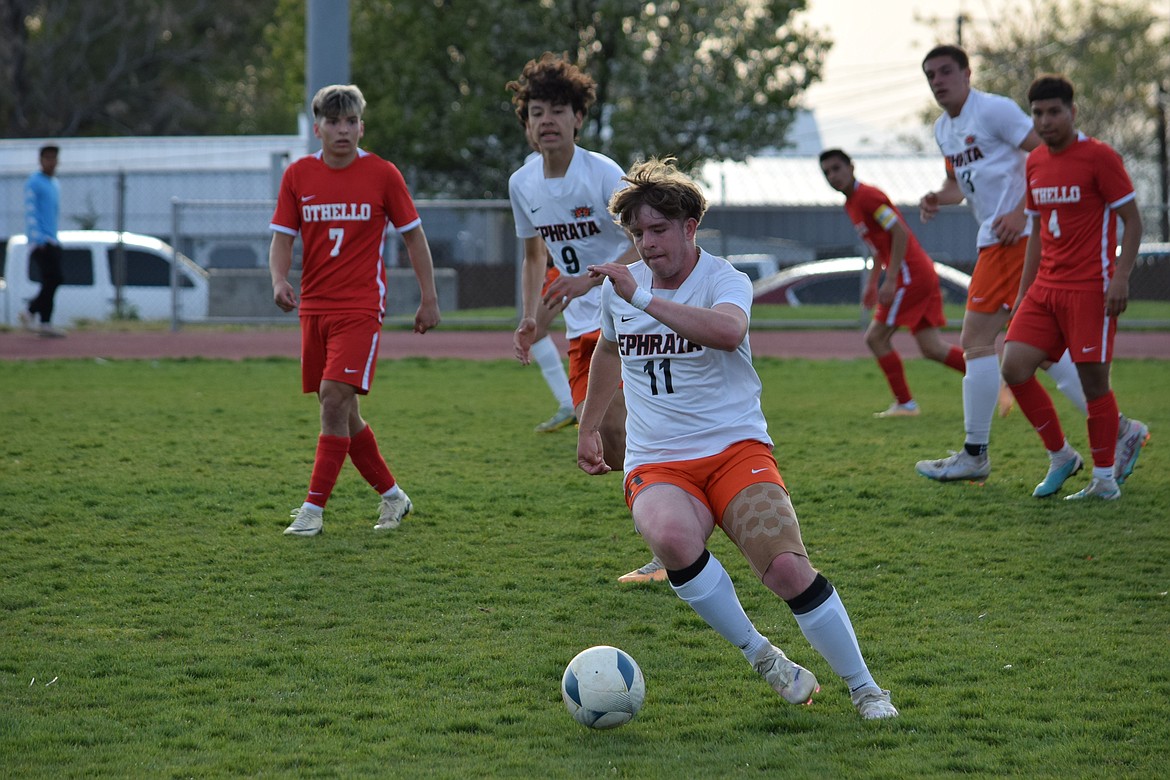 Ephrata senior Jaedon Truscott (11) clears the ball out from in front of the Tiger net during Tuesday’s match against Othello.