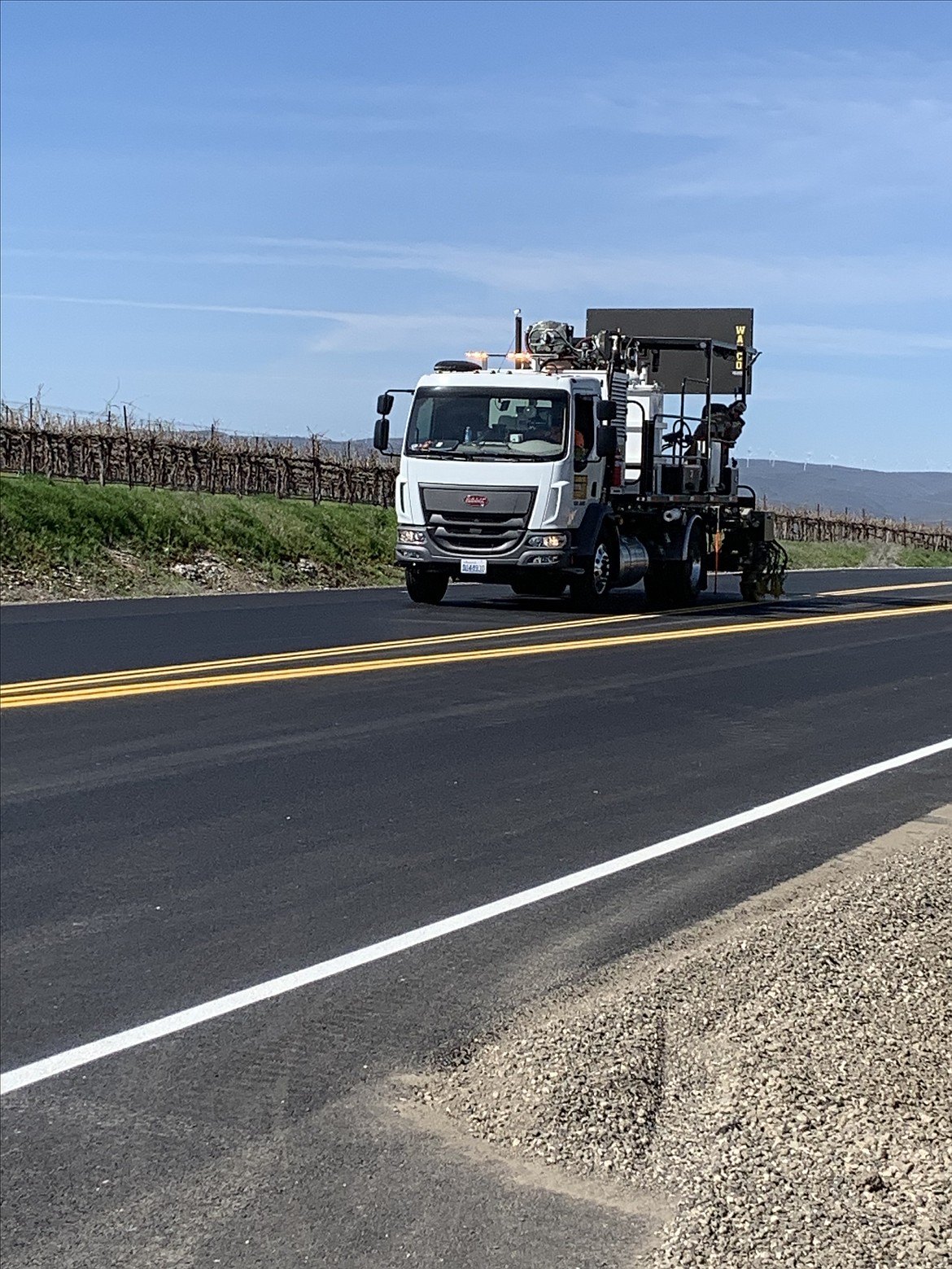 Construction crews add stripes in the project area of Silica Road last week. Sections of Silica Road and West Baseline Road were paved and widened to improve access to the Gorge Amphitheater.