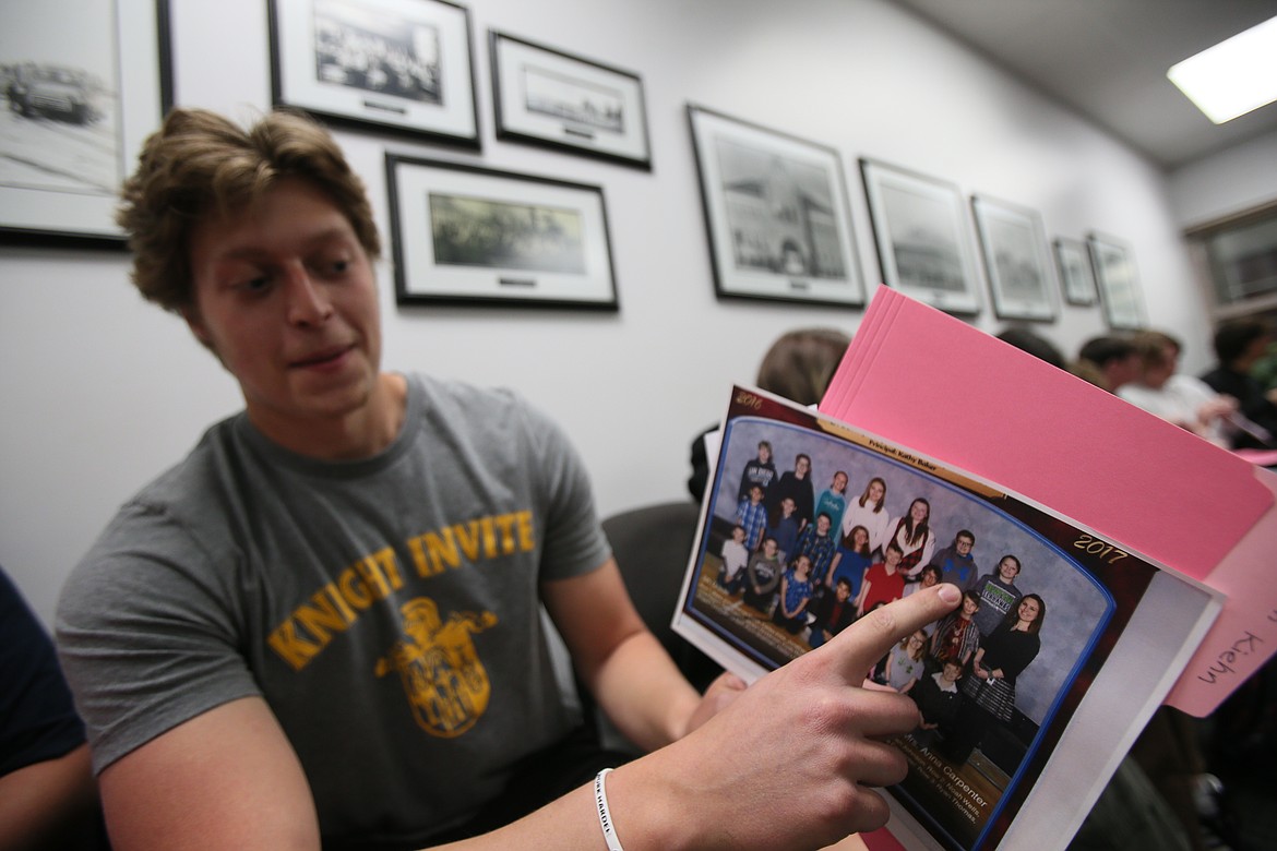 Post Falls High senior Jackson Kiehn points to himself in his fifth grade class picture Thursday morning after he and his classmates received the photos accompanied by letters they wrote to their future selves when they were the first fifth graders to attend Greensferry Elementary School.