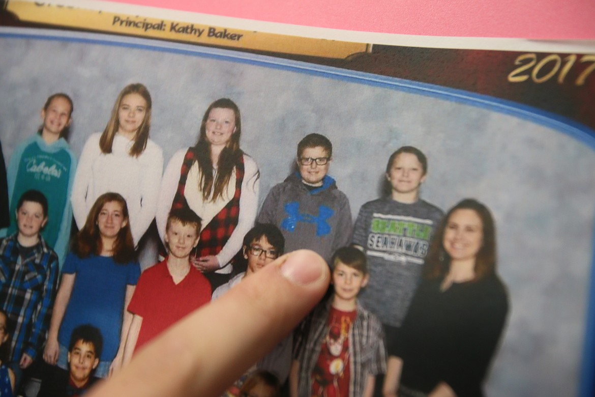 Jackson Kiehn points to his younger self in a photo of Greensferry Elementary School's first fifth grade class during the 2016-2027 school year. Many of the former Greensferry students are now seniors at Post Falls High, about to graduate.