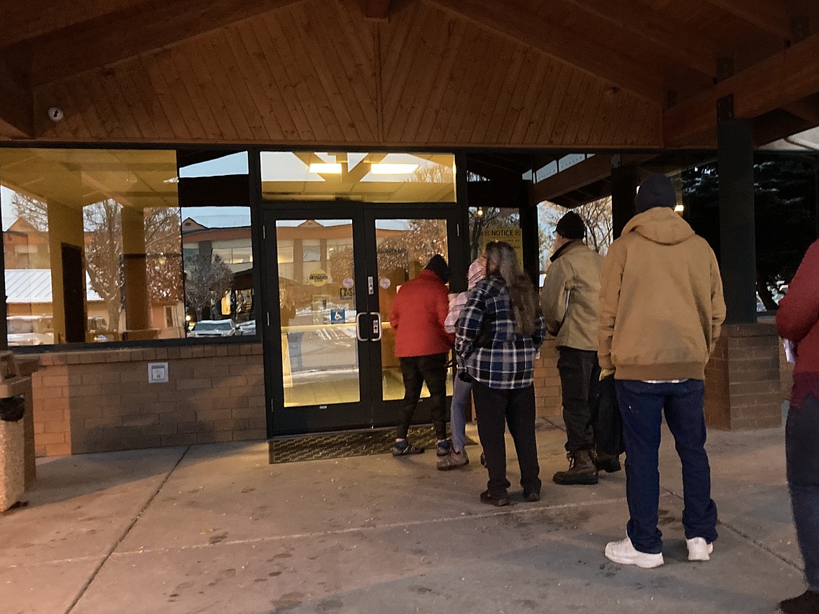 People line up outside a public assistance office in Missoula, Montana, before its doors open at 8 a.m. on Oct. 27, 2023, hoping to regain Medicaid coverage after being dropped from the government insurance program for people with low incomes and disabilities. (Katheryn Houghton/KFF Health News)