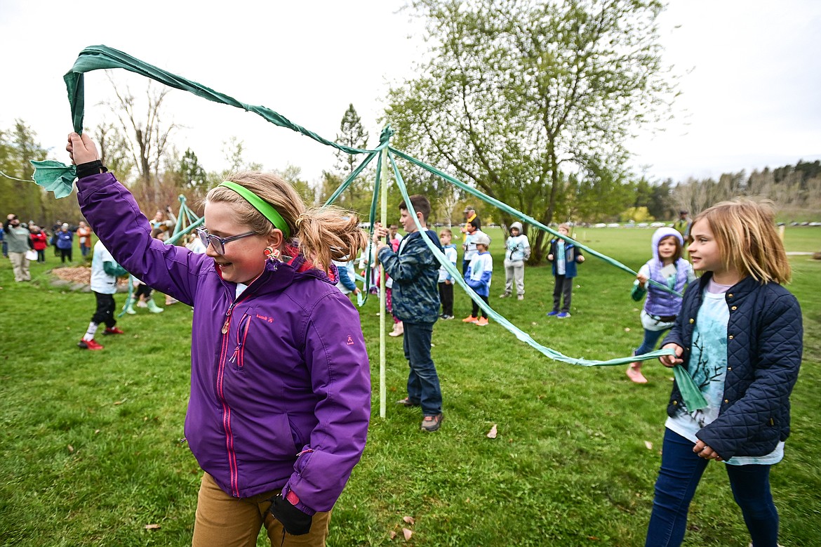 Third-grade students in Melaina Ames' class at Hedges Elementary School sing and dance around a Maypole during the Arbor Day celebration at Lawrence Park on Friday, April 26. (Casey Kreider/Daily Inter Lake)