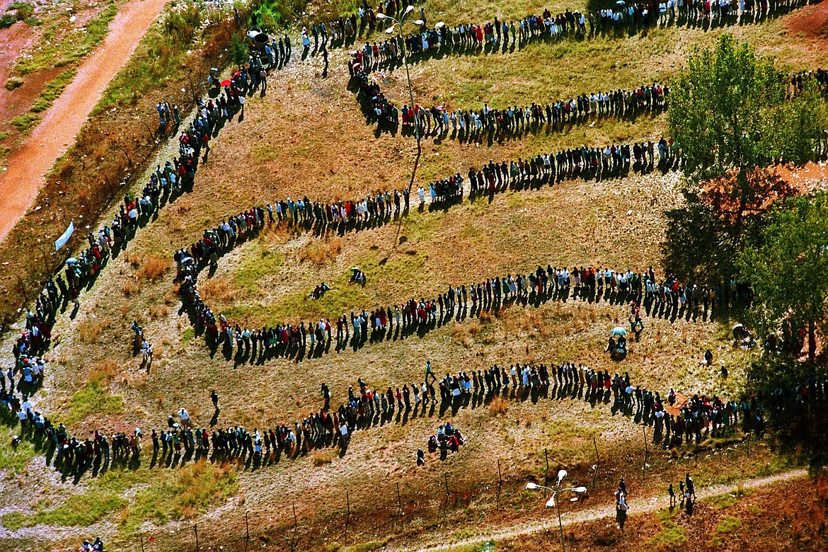 People queue to cast their votes In Soweto, South Africa April 27, 1994, in the country's first all-race elections. In 1994 people braved long queues to cast a vote after years of white minority rule which denied Black South Africans the vote. (AP Photo/Denis Farrell. File)