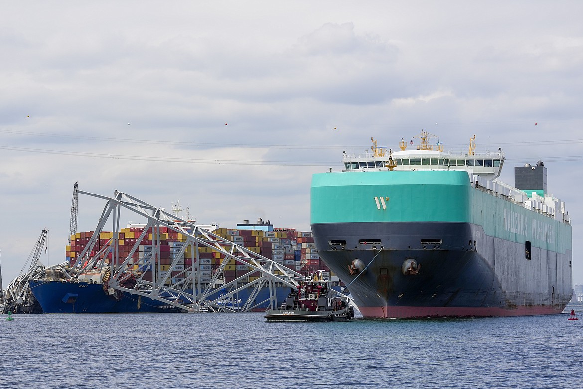 A cargo vessel moves through a newly opened deep-water channel in Baltimore after being stuck in the harbor since the Francis Scott Key Bridge collapsed four weeks ago, Thursday, April 25, 2024. (AP Photo/Matt Rourke)