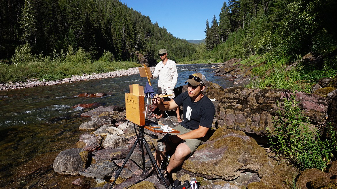 Kenneth Yarus and Richie Carter paint on the river in the Bob Marshall Wilderness. (Photo courtesy of the Hockaday Museum of Art)