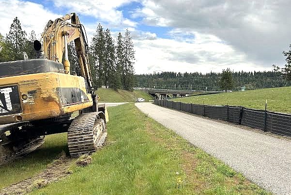 Construction equipment sits next to the Atlas bike trail just north of Interstate 90 on Friday afternoon.