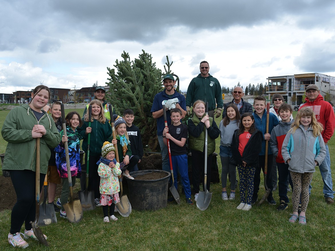 Students from Ramsey Magnet School and Coeur d’Alene Park Department staff gather after helping replant a tree transplant at Atlas Waterfront Park in a celebration of Arbor Day. The city was presented the Tree City USA Award for the 40th year.