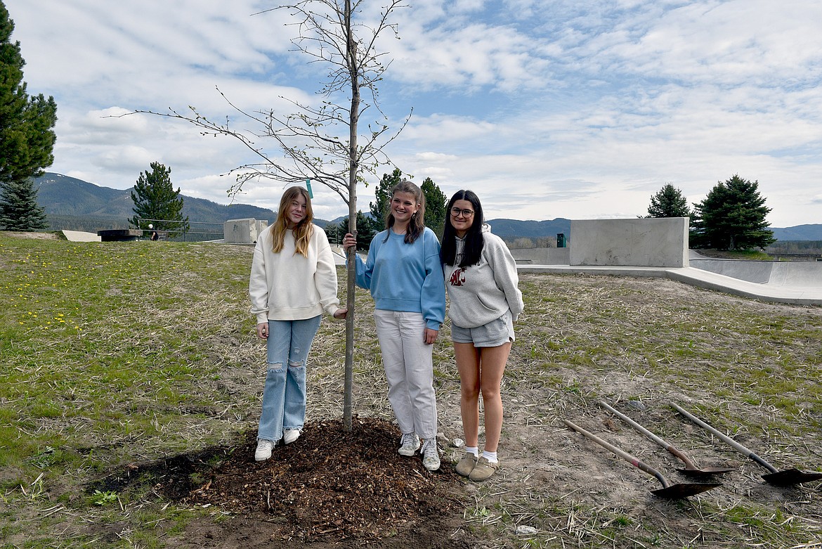 Students Astir Pulsifer, Iris Hunt and Lanie Fyall after planting the first of four trees on Arbor Day 2024 (Kelsey Evans/Pilot).