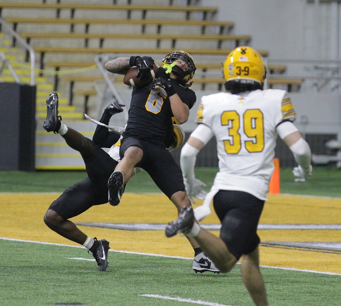 MARK NELKE/Press
Jordan Dwyer (6) of the Black team makes a leaping catch for a touchdown in the fourth quarter as Abraham Williams, rear, defends, and Jacob Skobis (39) looks on during Idaho's spring football game Friday night at the Kibbie Dome in Moscow.