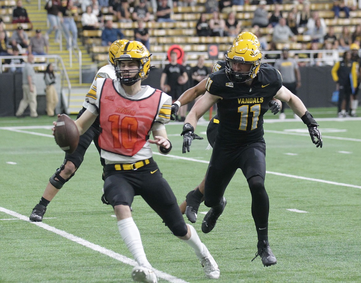 MARK NELKE/Press
Zach Johnson (11) of the Black team, the former Lake City High star, chases down White quarterback Jack Wagner for a sack during the first half of Idaho's spring football game Friday night at the Kibbie Dome.