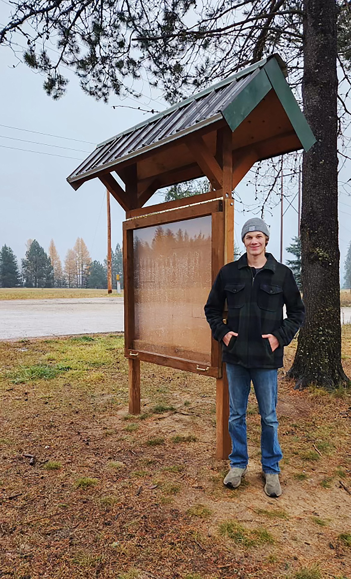 Ryan Doko stands by a community bulletin board by an old schoolhouse near his Sandpoint area home. Creation of the weather-friendly bulletin board allows community members to stay up-to-date with what is going on — and with each other, Doko said of why he picked it for an Eagle Scout project.