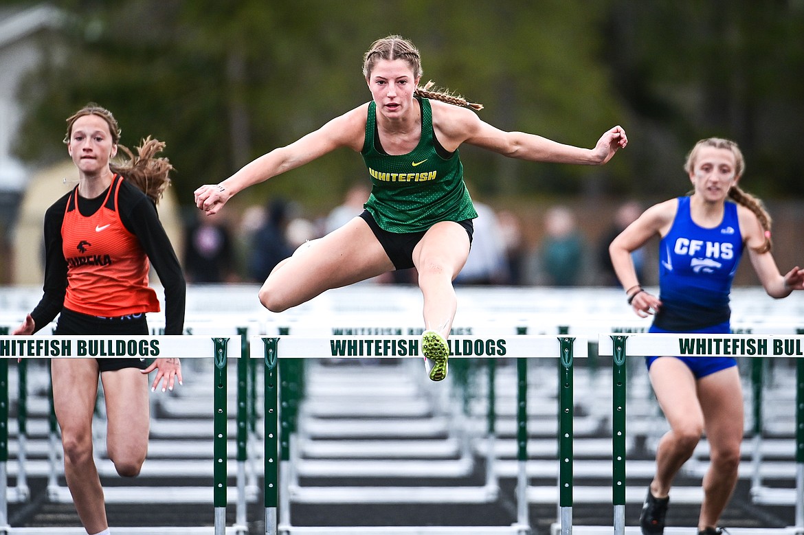 Whitefish's Hailey Ells clears a hurdle en route to a first place finish in the girls 100 meter hurdles at the Whitefish ARM Invitational on Saturday, April 27. (Casey Kreider/Daily Inter Lake)