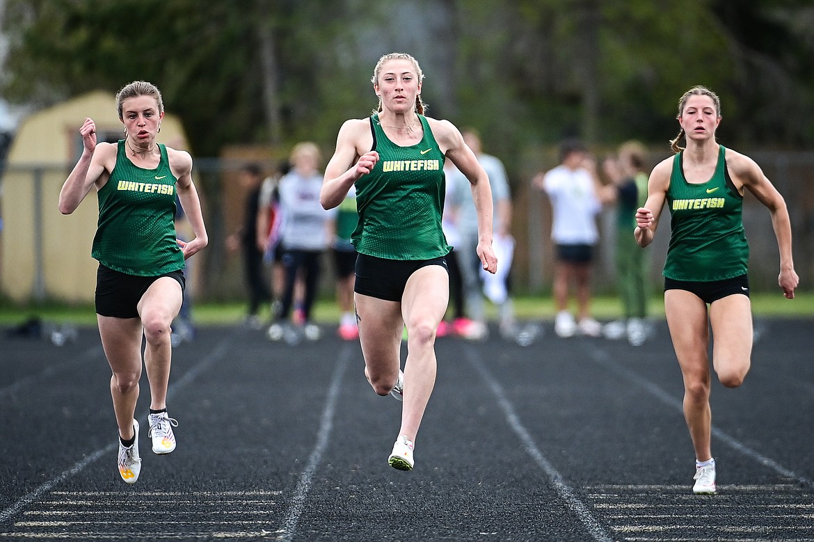 Whitefish's Brooke Zetooney, center, Rachael Wilmot, left, and Hailey Ells, right, took first, second and third in the girls 100 meter run at the Whitefish ARM Invitational on Saturday, April 27. (Casey Kreider/Daily Inter Lake)