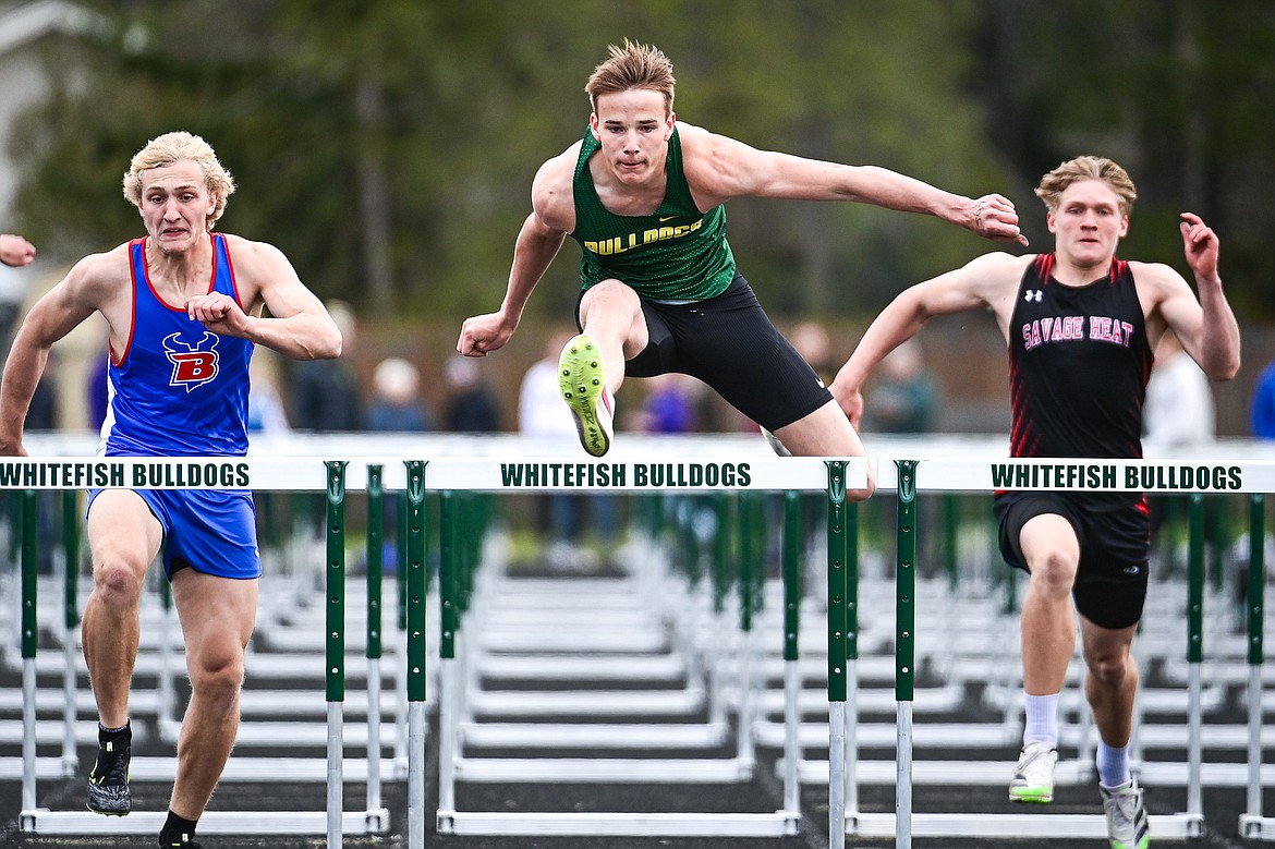 Whitefish's Carson Krack clears a hurdle en route to a first place finish in the boys 100 meter hurdles at the Whitefish ARM Invitational on Saturday, April 27. (Casey Kreider/Daily Inter Lake)