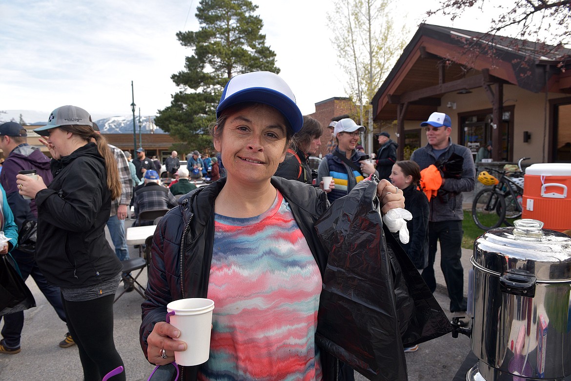 Volunteer equipped and ready to go with coffee and trash bag at Glacier Bank's annual Clean the Fish event Saturday morning (Kelsey Evans/Pilot).