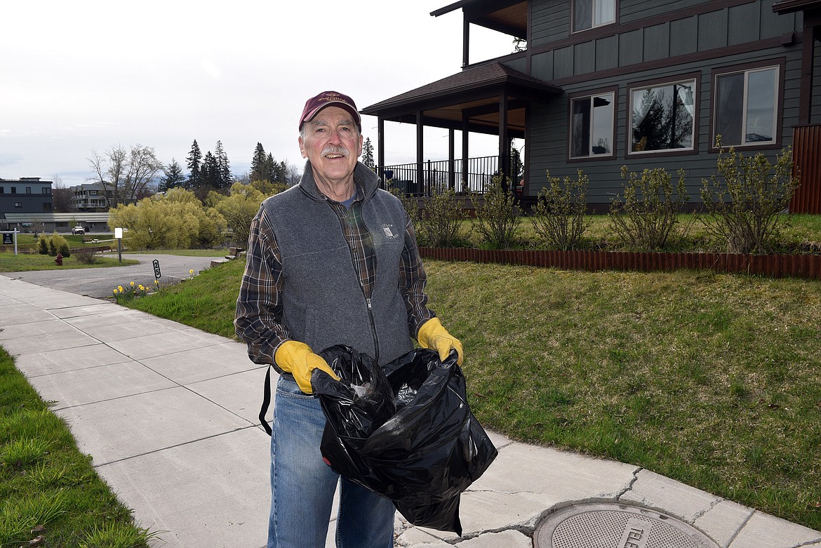 One of many volunteers cleaning up downtown for Clean the Fish (Kelsey Evans/Pilot).