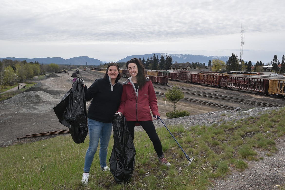 Volunteers on the edges of the Baker Ave. bridge for Clean the Fish on Saturday, April 27th (Kelsey Evans/Pilot).