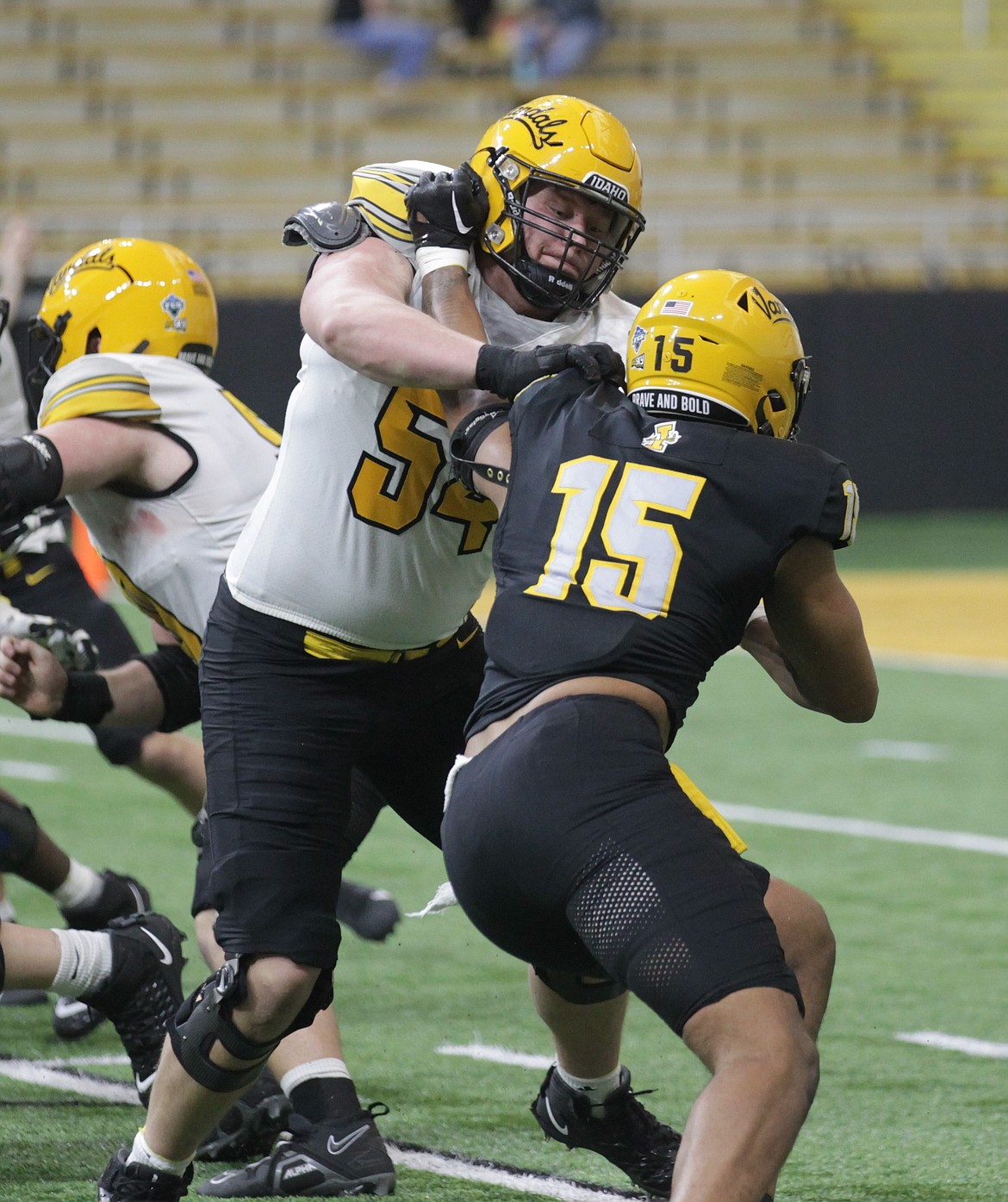 MARK NELKE/Press
Left tackle Alex Green (54) blocks Malakai Williams (15) during Idaho's spring football game Friday night at the Kibbie Dome in Moscow.