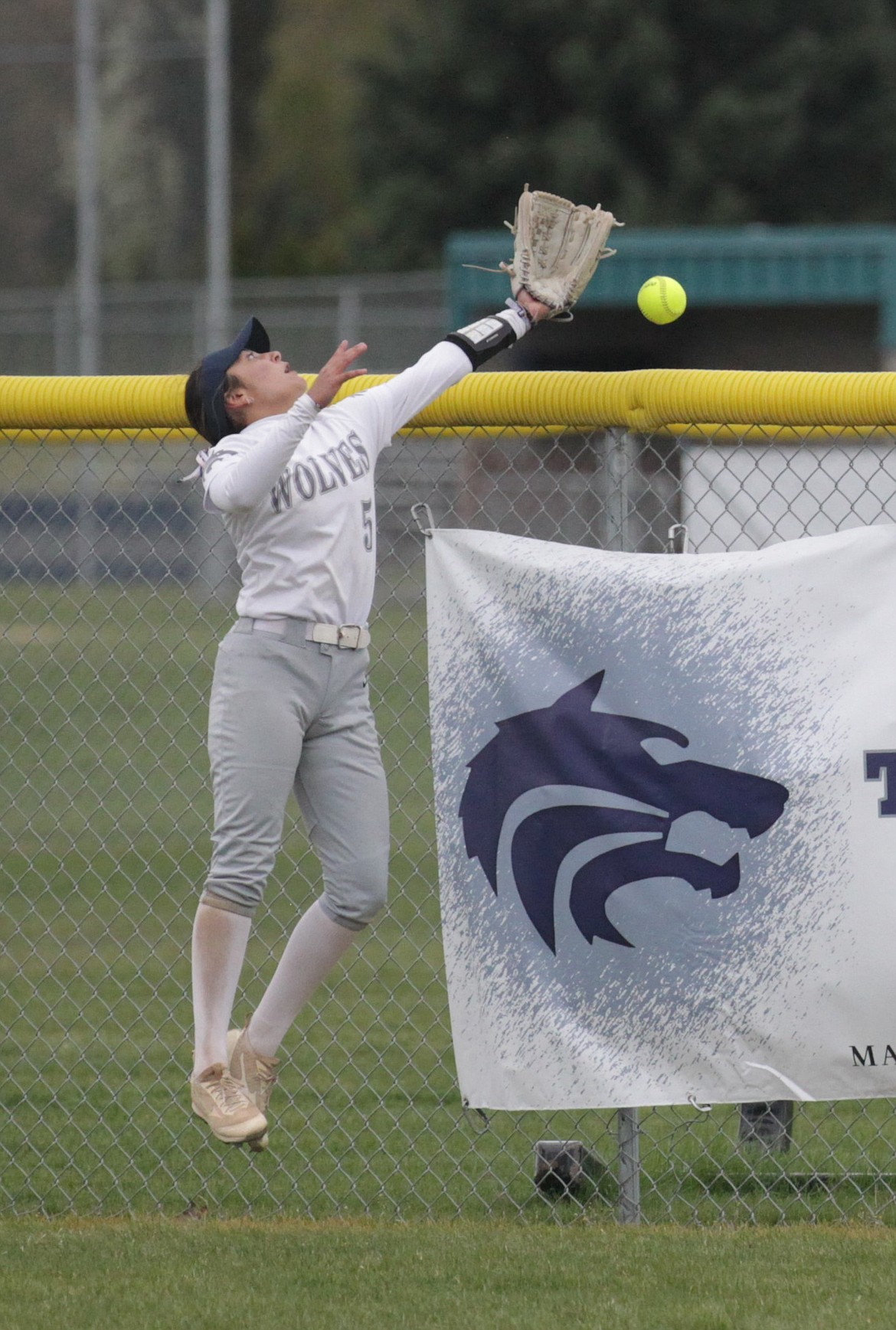 MARK NELKE/Press
Lake City center fielder Sammie Chavez makes a leaping try on a home run by Lakeland's Delilah Zimmerman which bounced off the top of the fence in the first game Saturday at Lake City High.