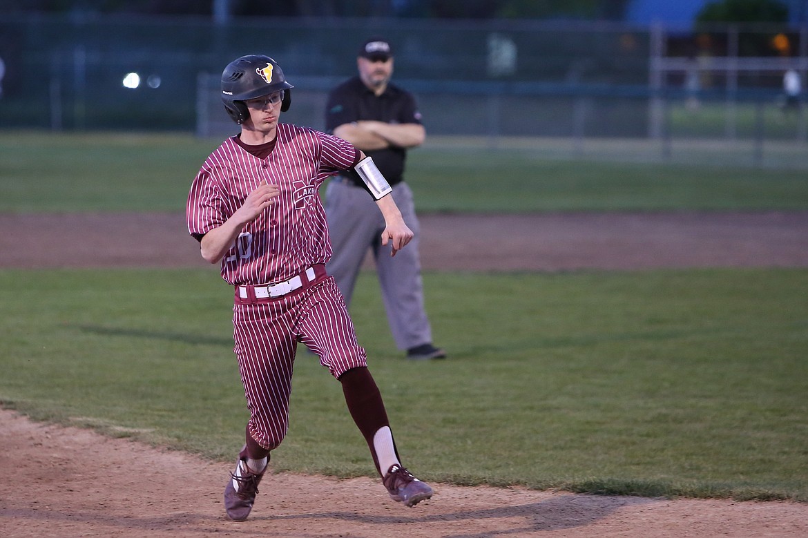 Moses Lake senior Nolan Crawford starts to slide into third base in the bottom of the ninth inning against Wenatchee. Crawford scored the game-winning run on the same play, reaching home plate after a passed ball got past the Panther third baseman.