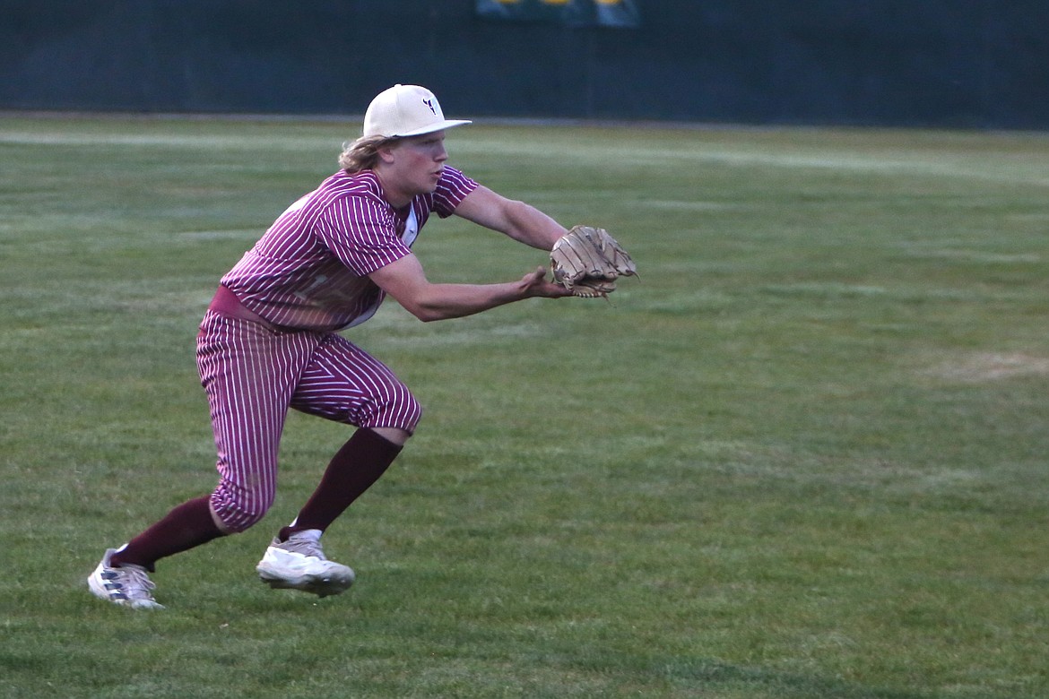 Moses Lake senior Willem Jansen leans forward to catch a fly ball in the outfield in the top of the eighth inning.