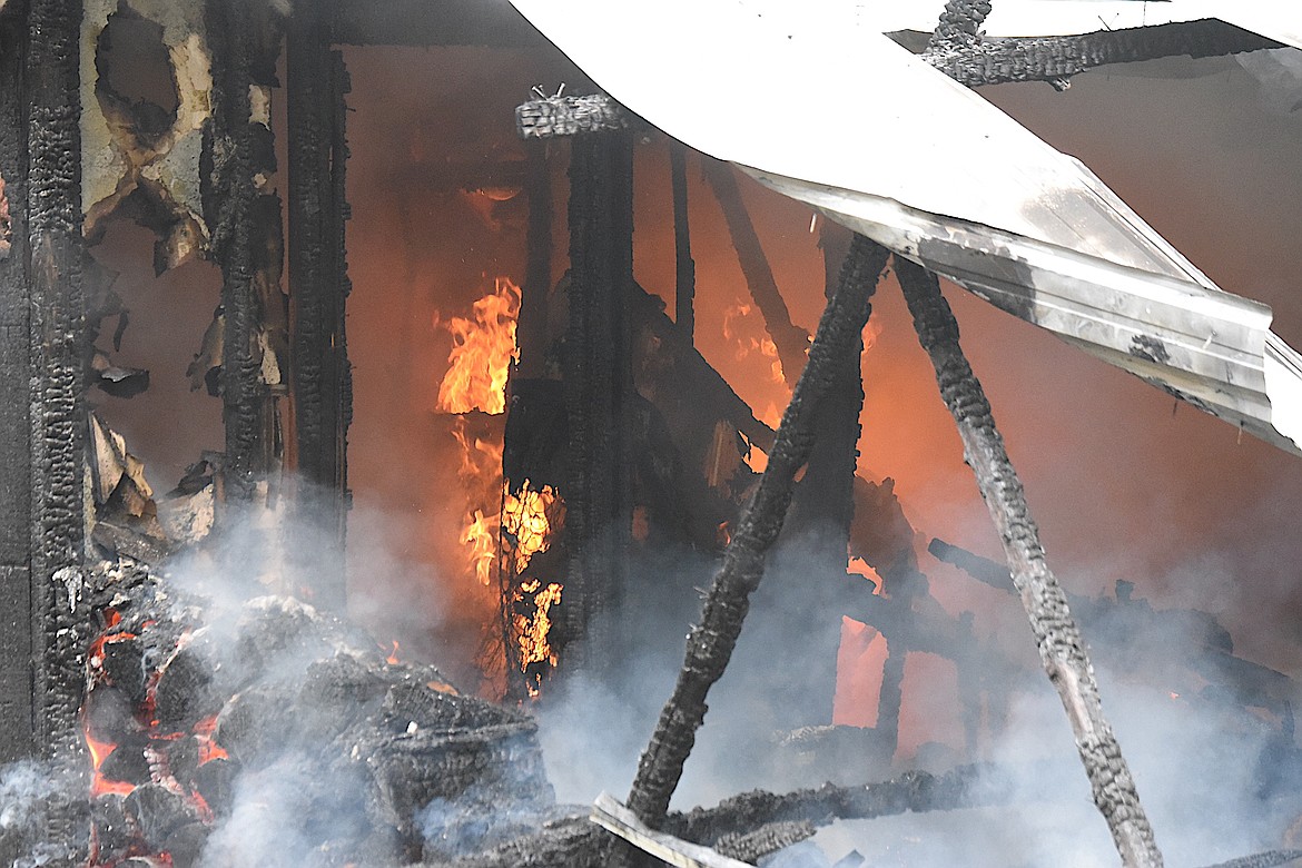 Flames roared through a small home Sunday afternoon south of Libby. A county resident died in the fire. (Scott Shindledecker/The Western News)