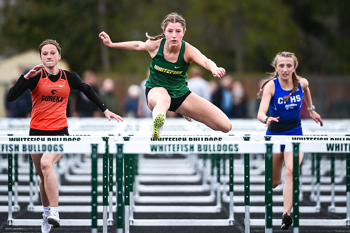 Whitefish's Hailey Ells clears a hurdle en route to a first place finish in the girls 100 meter hurdles at the Whitefish ARM Invitational on Saturday, April 27. (Casey Kreider/Daily Inter Lake)