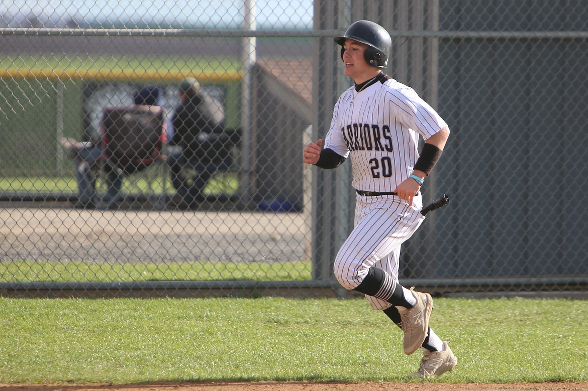 Almira/Coulee-Hartline junior Grayson Beal dashes to home plate during Saturday’s doubleheader against Republic. Beal leads the Warrior baseball team in hits (29) and RBI (33).