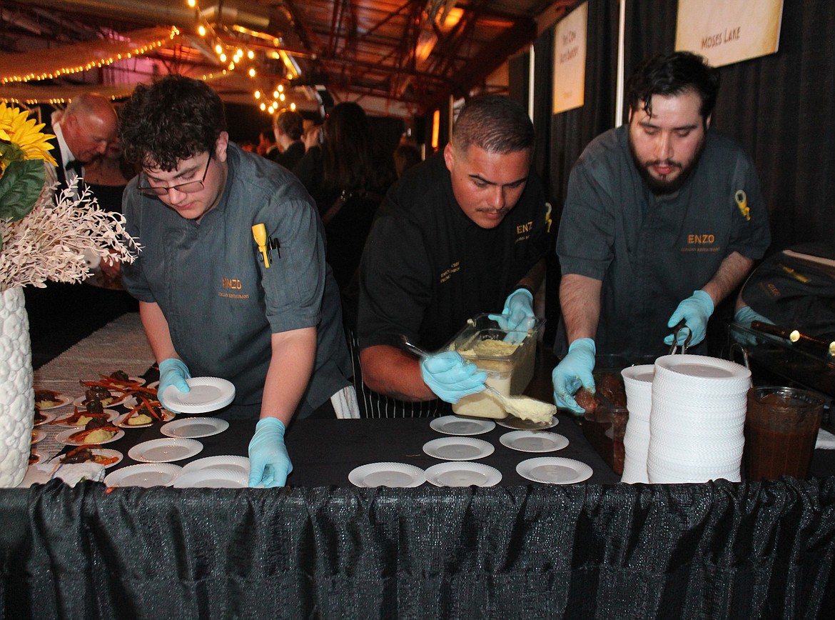 The crew of ENZO Italian Restaurant prepares plates during the  Bourbon & Bowties dinner.