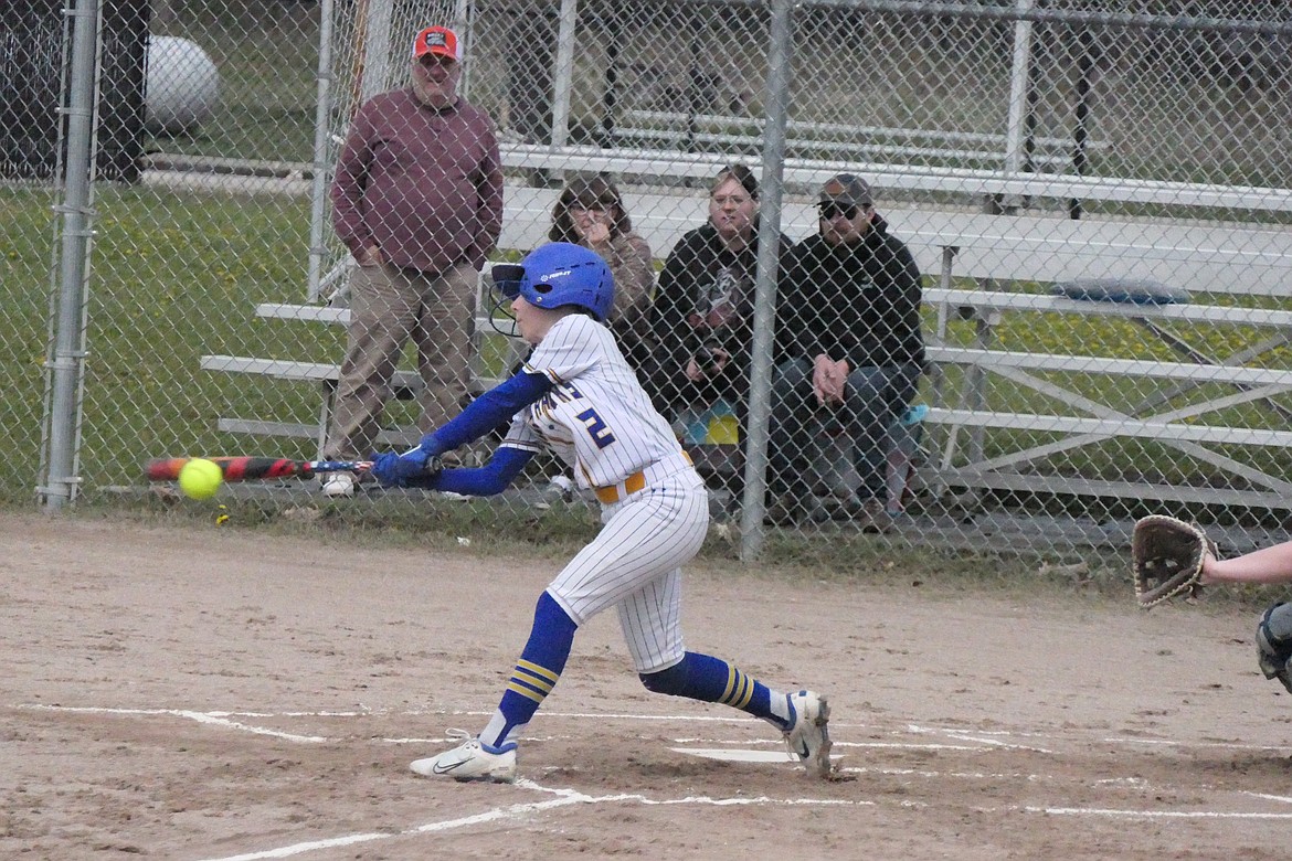 Senior MacKenzie Robinson makes contact with an incoming Deer Lodge pitch during their softball game Saturday afternoon in Thompson Falls.  (Chuck Bandel/VP-MI)