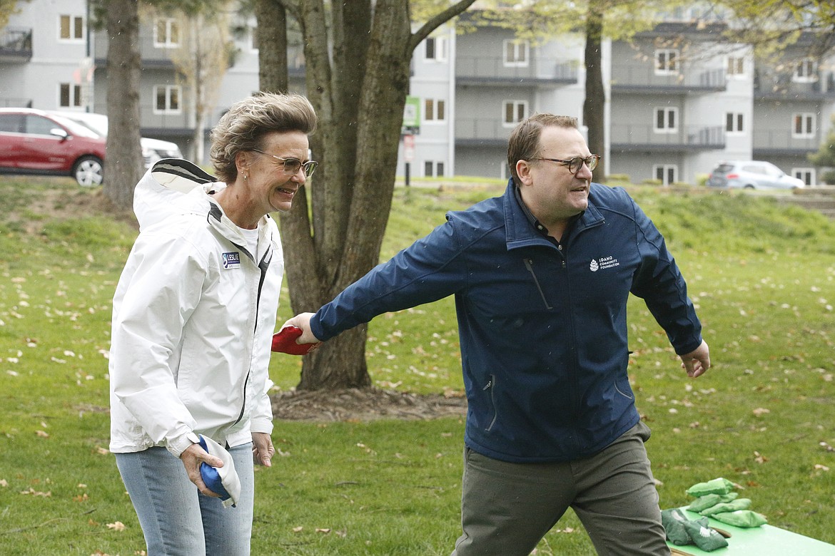 Despite a burst of hail, Leslie Johnson, director of development and communication for Safe Passage, and Peter Faucher, philanthropic advisor for the Idaho Community Foundation, played cornhole at the local Idaho Gives kickoff event.